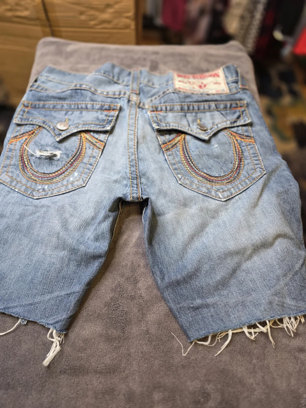 TRUE RELIGION Light Wash Cutoff Denim Shorts with Embroidered Back Pockets